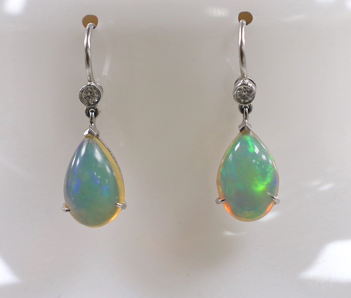 A pair of white metal, opal and diamond set earrings, overall 25mm, gross weight 2.6 grams.